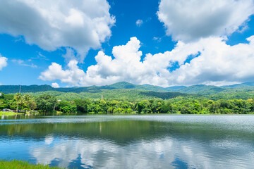 Fototapeta premium a public place leisure travel landscape lake views at Ang Kaew Chiang Mai University and Doi Suthep nature forest Mountain views spring cloudy sky background with white cloud.