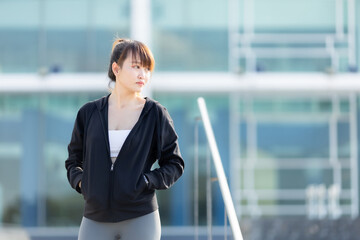 Portrait of beautiful asian Young woman in Black robe sportswear working out outside. training on public equipment in outdoor at park. concept Exercise Healthy lifestyle.