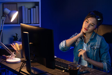 Young beautiful Asian businesswoman taking break with stretching body with ache symptom for relaxing muscle after finishing overworked load report at neon light modern office at night time. Stratagem.