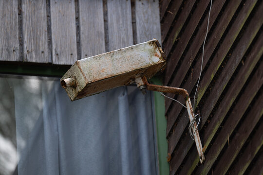 Old and rusty fake security camera