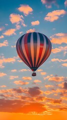 Obraz premium A hot air balloon ascending into the sky at sunrise, surrounded by soft clouds and warm colors