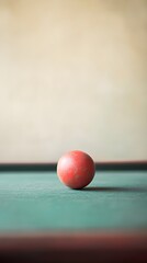 A minimalist composition of a foosball ball resting on a foosball table, emphasizing the texture and color against a light backdrop