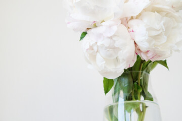Bouquet Of White Peonies Is Standing In A Glass Vase On A White Background, Providing A Sense Of Elegance And Simplicity. Close Up