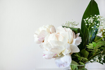 Bouquet Of Fresh White Peonies And Baby's Breath Arranged In A Glass Vase, Creating A Delicate And Romantic Atmosphere