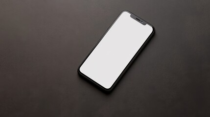 Top view of a smartphone with a blank screen placed on a plain surface, highlighting the device's sleek design