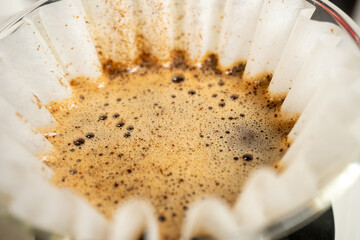 brewing pour over filter coffee in close up