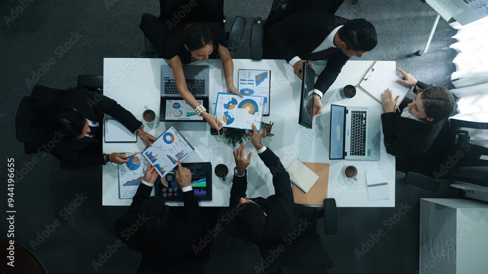 Poster top down aerial view of business people discussing about financial strategy on table with document a