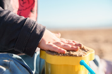 An adorable little toddler is walking along beach, a beautiful landscape and a cute childhood concept. Samara, Russia - 15 June 2024