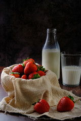 still life bowl of red strawberries on a dark background