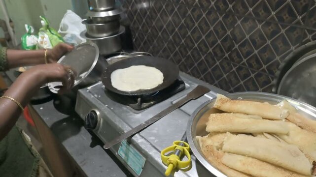 Howrah, West Bengal, India - 26.01.2022 : Home made preparation of Patishapta Pitha, a famous Bengali Dessert Recipe, during Winter season. Patishapta is a type of pithe made in celebratory occasions.