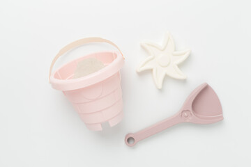 Cute toys for playing with sand on color background, top view