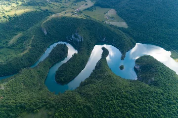aerial view of a picturesque river meandering among the hills © bigguns