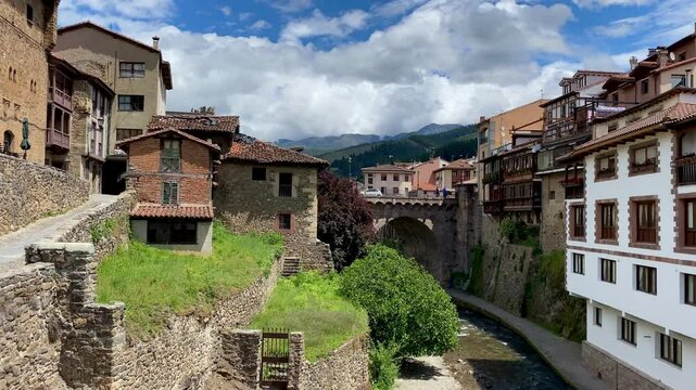 Spain Potes pan across river town Picos de Europa Cantabria