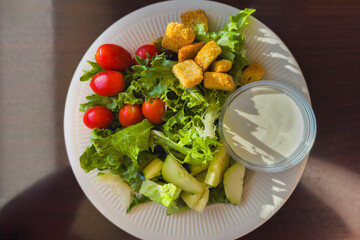 Healthy salad served with crisp vegetables, croutons, and creamy dressing.