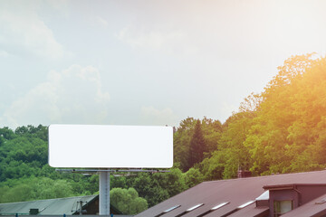 Blank billboard on roadside with road