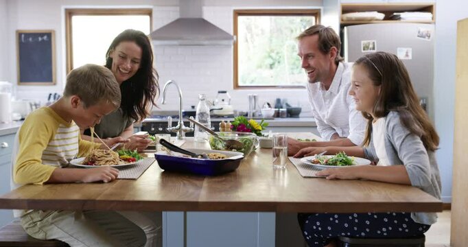Food, happy and spaghetti with family eating in kitchen for health, love and together. Smile, lunch and nutrition with parents and children at dining table in home for dinner, wellness and bonding