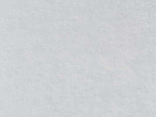 Natural snow texture. Smooth surface of clean fresh snow. Snowy ground. Winter background with snow patterns. Perfect for Christmas and New Year design. Closeup top view.