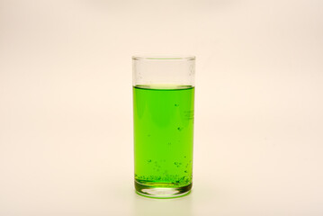 A glass glass with soda on a white background. Juice in a glass.