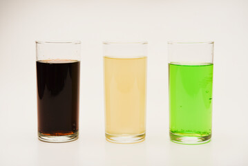Glass glasses with soda on a white background. Juice in three glasses.