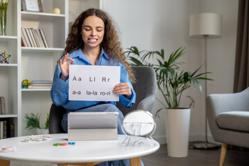 Cute long-haired speech therapist conducting an online tutorial