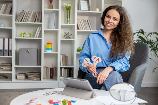 Smiling young speech therapist feeling happy after a good session