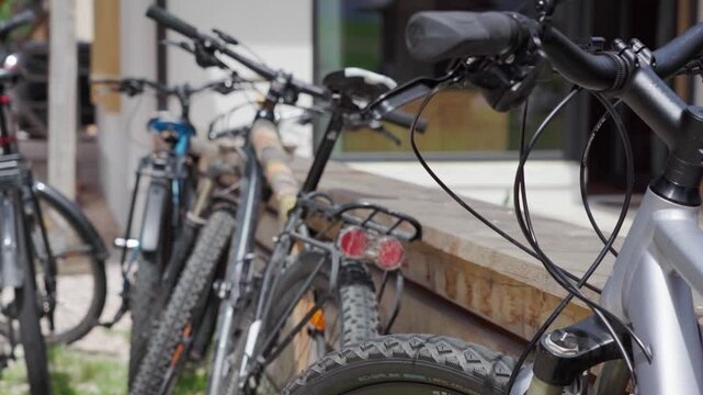 Close up shot of Mountainbikes lean against a fence made Out of wood