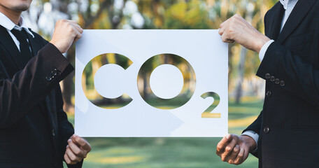 Group of business people stand united, holding eco-friendly idea and concept for environmental...