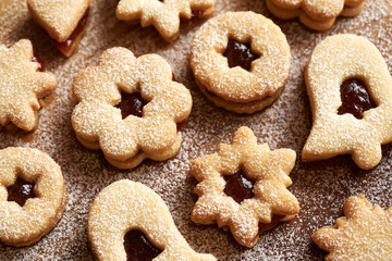 Closeup of homemade Linzer Christmas cookies filled with marmalade and dusted with sugar