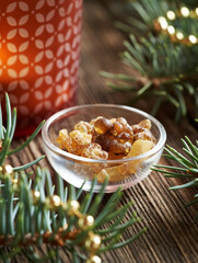 Frankincense resin in a glass bowl with Christmas decoration. Incense and ingredient for essential oils.