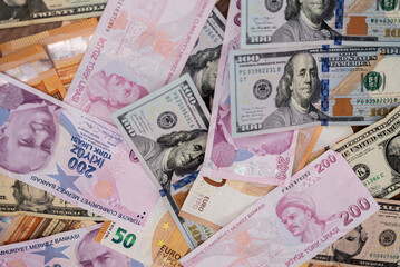 Various international currencies including US dollars, euros, and Turkish lira arranged haphazardly. Concept of global finance, currency exchange, and economic diversity 