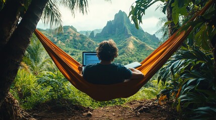 Person relaxing in a hammock with a laptop, overlooking a tropical mountain landscape.