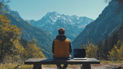 Man working on laptop with mountain view.