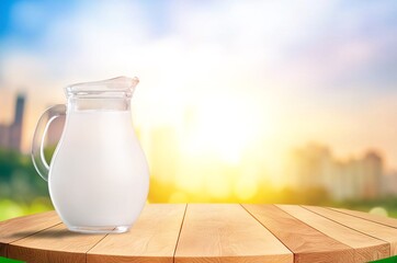 A glass of fresh tasty milk on table