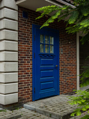 blue restored retro entrance door on a brick house