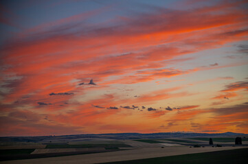  sunset over the endless fields of castilla spain that shows agriculture fields empty after the harvest