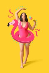 Happy young woman in stylish swimsuit and with drawn inflatable ring in shape of flamingo on yellow background