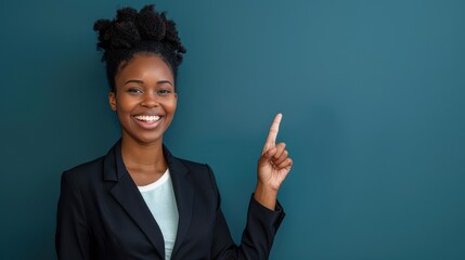 Smiling African woman in professional attire pointing upward