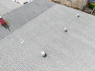 Daytime Drone Images of Asphalt Shingles on a Commercial Building with a Firewall. 