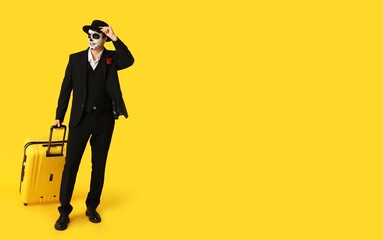 Male tourist dressed for Halloween on yellow background with space for text
