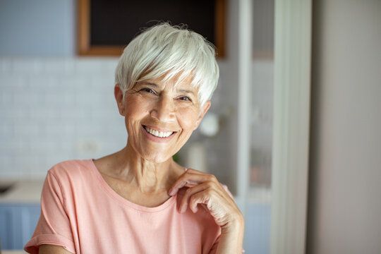 Smiling senior woman portrait in modern kitchen