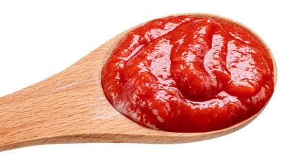 Wooden spoon of tomato sauce or ketchup close-up on a white background. Top view.