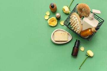 Composition with cosmetic products, bath supplies and rose flowers on color background