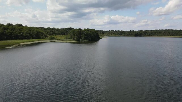 Fly over green nature and lake at the K&ouml;lpingsee area which is close located to Jabel