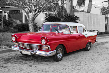 red and white classic car in the streets of havanna cuba