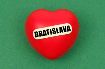 A vibrant red heart symbolizing love for Bratislava against a green backdrop, capturing the spirit of the city's charm and warmth