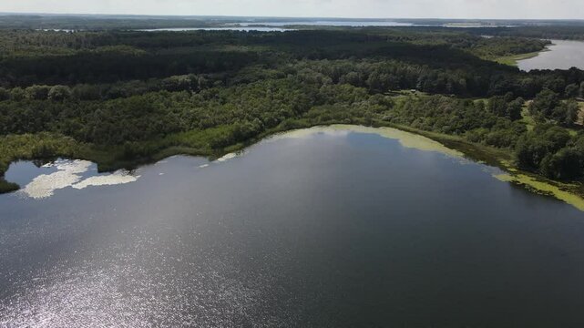 Fly over green nature and lake at the K&ouml;lpingsee area which is close located to Jabel