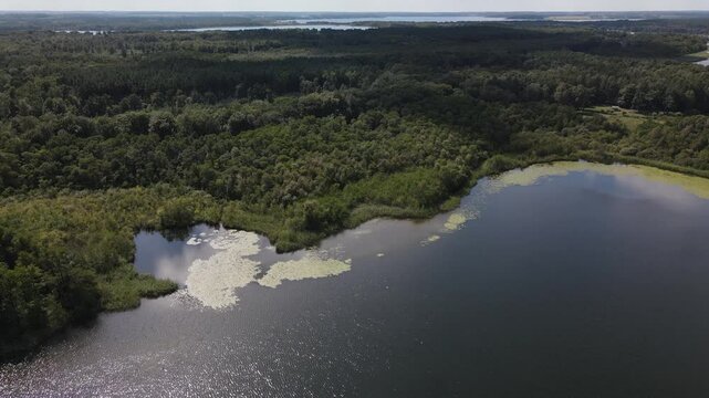 Fly over green nature and lake at the K&ouml;lpingsee area which is close located to Jabel