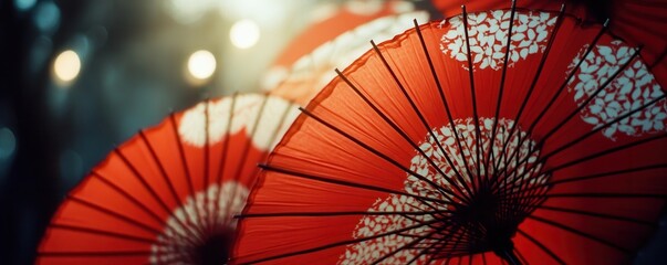 Close-up of vibrant red umbrellas with intricate white patterns, capturing traditional artistry and cultural elegance in a mesmerizing display.