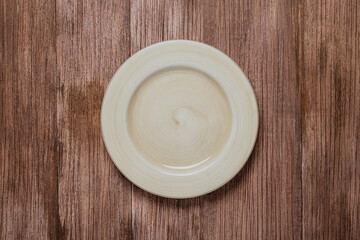 flat lay of ceramic plate mock up over rustic wooden brown table