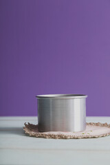 metal cylinder mock up on vintage doily and bright purple background